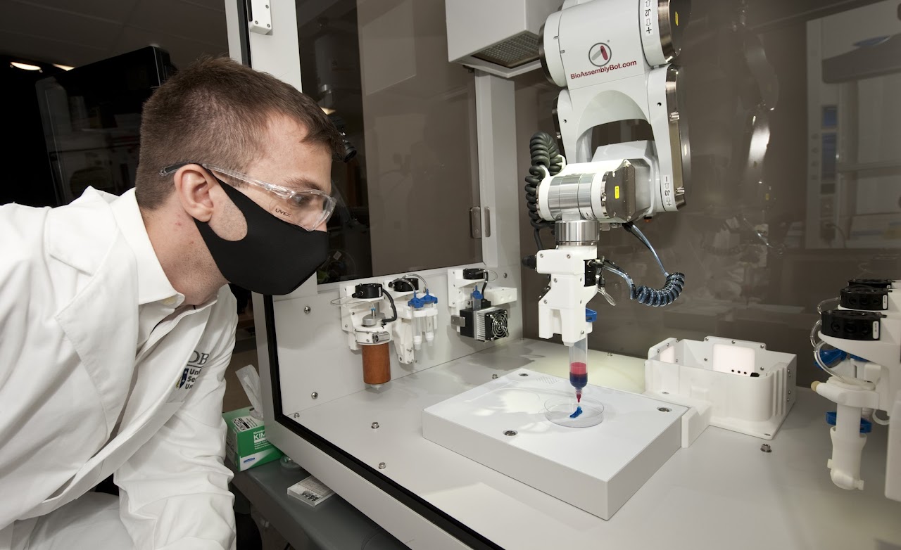 Nicholas Chartrain working with a bioprinter in the lab